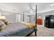 Bright bedroom with four-poster bed, neutral walls, ceiling fan, and hardwood dresser at 450 Bay Grove Se Rd, Loganville, GA 30052