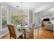 Bright dining area features a large bay window with elegant chandelier lighting at 450 Bay Grove Se Rd, Loganville, GA 30052