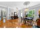 Elegant dining room featuring hardwood floors, sophisticated trim, and sun-filled windows for memorable gatherings and comfortable dining at 450 Bay Grove Se Rd, Loganville, GA 30052