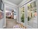 Entryway with French doors leading to a covered outdoor living space with white columns and seating at 450 Bay Grove Se Rd, Loganville, GA 30052
