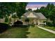 Beautiful home featuring a manicured lawn, mature trees, and a classic front porch perfect for outdoor enjoyment at 450 Bay Grove Se Rd, Loganville, GA 30052