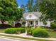 Charming traditional home featuring a manicured lawn, lush landscaping, and a welcoming front porch at 450 Bay Grove Se Rd, Loganville, GA 30052