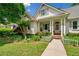 Charming home with inviting curb appeal, featuring mature trees, an American flag, and a well-manicured lawn at 450 Bay Grove Se Rd, Loganville, GA 30052