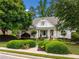 Charming two-story home with manicured front yard, lush landscaping and a welcoming entrance at 450 Bay Grove Se Rd, Loganville, GA 30052