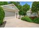 Detached two-car garage with charming side entrance and mature landscaping at 450 Bay Grove Se Rd, Loganville, GA 30052