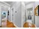 Hallway with hardwood floors and access to a powder room and other rooms at 450 Bay Grove Se Rd, Loganville, GA 30052