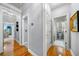 Hallway with hardwood floors that leads to multiple rooms and a bathroom at 450 Bay Grove Se Rd, Loganville, GA 30052