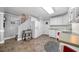 Functional kitchen with white cabinetry, tile flooring, and casual sports decor throughout at 450 Bay Grove Se Rd, Loganville, GA 30052