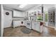 Bright, well-lit kitchen featuring all white cabinets, stainless steel appliances, and a view of the backyard at 450 Bay Grove Se Rd, Loganville, GA 30052