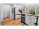 Modern kitchen boasts stainless appliances, breakfast nook, and hardwood floors at 450 Bay Grove Se Rd, Loganville, GA 30052