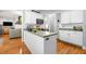 White kitchen boasts stainless appliances, countertops, and hardwood floors at 450 Bay Grove Se Rd, Loganville, GA 30052