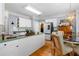 Bright kitchen featuring white cabinets, countertops, hardwood floors, and a breakfast nook for cozy dining experiences at 450 Bay Grove Se Rd, Loganville, GA 30052