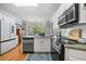 Modern kitchen boasts stainless appliances, breakfast nook, and hardwood floors at 450 Bay Grove Se Rd, Loganville, GA 30052
