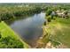 Scenic aerial view of a serene lake surrounded by lush greenery and beautiful residential properties at 450 Bay Grove Se Rd, Loganville, GA 30052