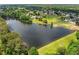 Scenic aerial view of a serene lake surrounded by lush greenery and beautiful residential properties at 450 Bay Grove Se Rd, Loganville, GA 30052