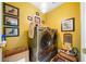 Bright laundry room boasts modern washer, dryer, and colorful decor at 450 Bay Grove Se Rd, Loganville, GA 30052