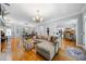 Open-concept living area features hardwood floors, neutral decor, and seamless flow between spaces for modern living and entertaining at 450 Bay Grove Se Rd, Loganville, GA 30052