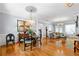 Bright living room with hardwood floors, elegant lighting, and classic trim details for sophisticated entertaining and comfortable living at 450 Bay Grove Se Rd, Loganville, GA 30052