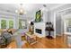 Living room boasts a cozy fireplace, neutral sofa, hardwood floors, and outdoor access for relaxed living and entertaining at 450 Bay Grove Se Rd, Loganville, GA 30052