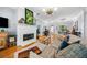 Inviting living room with fireplace, neutral color scheme, and hardwood floors offers a cozy and stylish space to relax and entertain at 450 Bay Grove Se Rd, Loganville, GA 30052