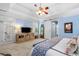 Spacious main bedroom suite featuring blue walls, carpet, a tray ceiling and a ceiling fan with light kit at 450 Bay Grove Se Rd, Loganville, GA 30052