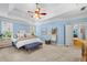 Large main bedroom with tray ceiling, decor, and ample natural light from windows at 450 Bay Grove Se Rd, Loganville, GA 30052