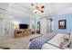 Spacious primary bedroom with tray ceilings, a ceiling fan, and sliding door that leads to the outside at 450 Bay Grove Se Rd, Loganville, GA 30052
