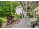 Covered patio with outdoor seating and lush landscaping, creating a serene outdoor living space at 450 Bay Grove Se Rd, Loganville, GA 30052