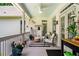 Covered porch has ceiling fans, comfortable seating, and decorative accents at 450 Bay Grove Se Rd, Loganville, GA 30052