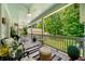 Covered porch with comfortable seating, ceiling fans, and views of the backyard at 450 Bay Grove Se Rd, Loganville, GA 30052