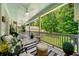 Relaxing covered porch with plush seating, ceiling fans, and a view of the lush backyard at 450 Bay Grove Se Rd, Loganville, GA 30052