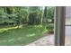 A serene backyard offers ample green space, framed by mature trees visible through the window at 50 Stonington Pl, Marietta, GA 30068