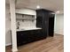 Finished basement wet bar area featuring dark cabinets and stainless steel sink at 50 Stonington Pl, Marietta, GA 30068