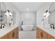 Bright bathroom featuring dual vanities, quartz counters, modern lighting, and a luxurious soaking tub at 50 Stonington Pl, Marietta, GA 30068