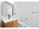 Modern bathroom features a wooden vanity with black hardware, toilet and a large mirror at 50 Stonington Pl, Marietta, GA 30068