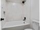 Bright bathroom with a white bathtub and tile, paired with black hardware at 50 Stonington Pl, Marietta, GA 30068