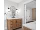 Stylish bathroom with wooden vanity, modern mirror, and an open doorway at 50 Stonington Pl, Marietta, GA 30068