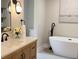 Stylish bathroom with wood cabinets, modern fixtures, and a luxurious soaking tub for relaxation at 50 Stonington Pl, Marietta, GA 30068