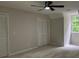 Spacious bedroom featuring plush carpeting, a ceiling fan, and a double door closet at 50 Stonington Pl, Marietta, GA 30068