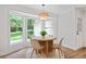 Bright breakfast nook features a modern table and a bay window with a view of the lush backyard at 50 Stonington Pl, Marietta, GA 30068