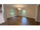 Bright dining room with hardwood floors, neutral walls, and a modern chandelier beneath two large windows at 50 Stonington Pl, Marietta, GA 30068