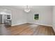 Open dining area featuring new hardwood floors and modern light fixture, flowing into the kitchen at 50 Stonington Pl, Marietta, GA 30068