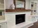 Close up of fireplace with white painted brick, wood mantle and built-in bookshelves at 50 Stonington Pl, Marietta, GA 30068