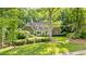 Charming front exterior with well-manicured landscaping and large front yard creates a welcoming curb appeal at 50 Stonington Pl, Marietta, GA 30068