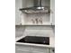 Modern kitchen featuring a smooth cooktop and stylish vent hood at 50 Stonington Pl, Marietta, GA 30068