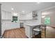 Modern kitchen with white cabinets, stainless steel appliances, and a breakfast bar seating adds convenience at 50 Stonington Pl, Marietta, GA 30068