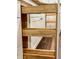 Detail of pull-out wooden shelving in kitchen cabinetry with stainless steel drawer slides at 50 Stonington Pl, Marietta, GA 30068