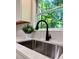 Kitchen sink and faucet with white marble-look countertop and view from window at 50 Stonington Pl, Marietta, GA 30068