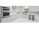 Eat-in kitchen featuring stainless appliances, modern white cabinets and hardware at 50 Stonington Pl, Marietta, GA 30068