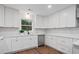 Bright kitchen with white cabinets, stainless steel appliances, and a view of nature from the window at 50 Stonington Pl, Marietta, GA 30068